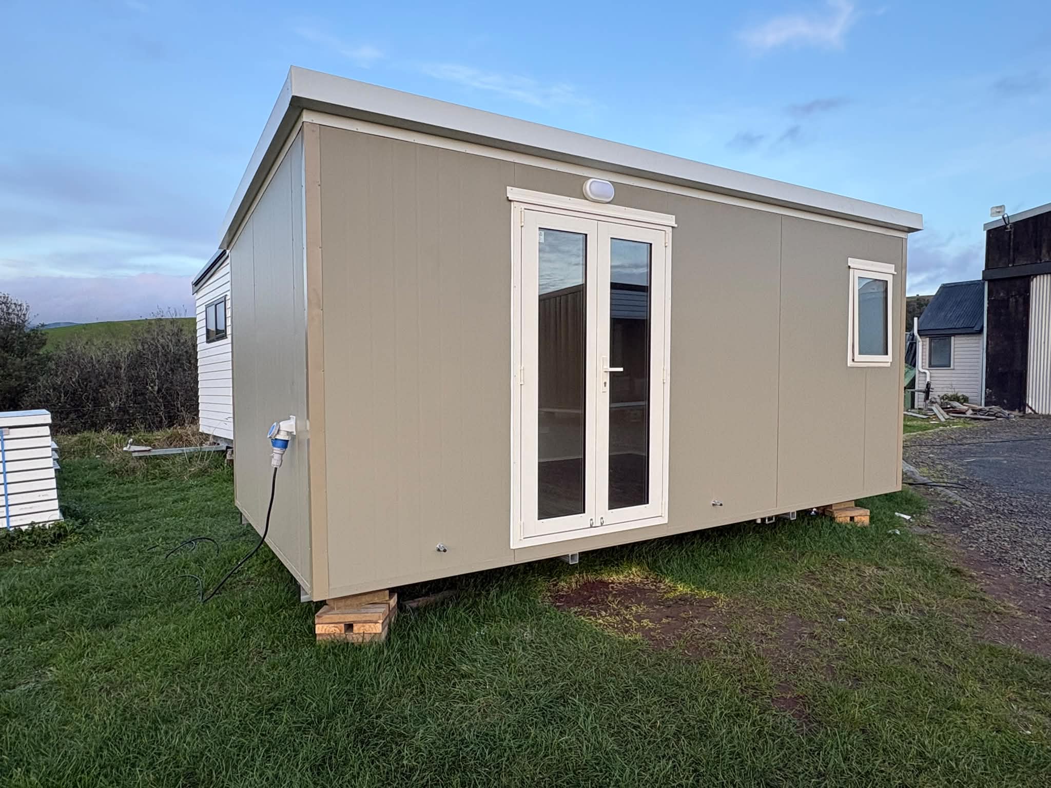 5.4×2.7 granny flat tiny home on a rural site, front-angle daylight view