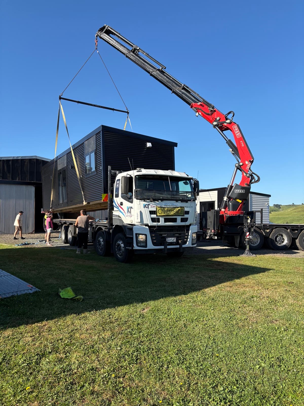 Tiny home being lifted onto site by Hiab crane