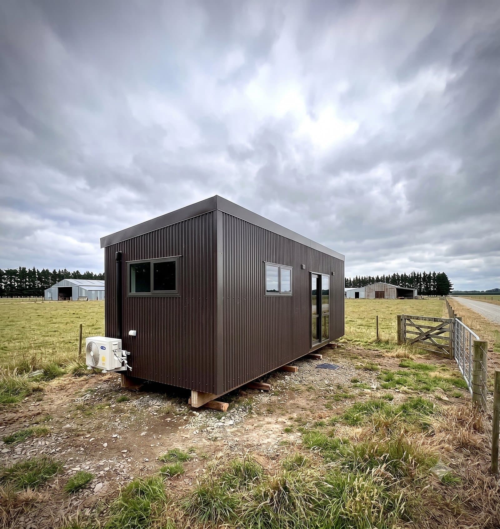 SHS dark-tone tiny home cabin sited on a working NZ farm