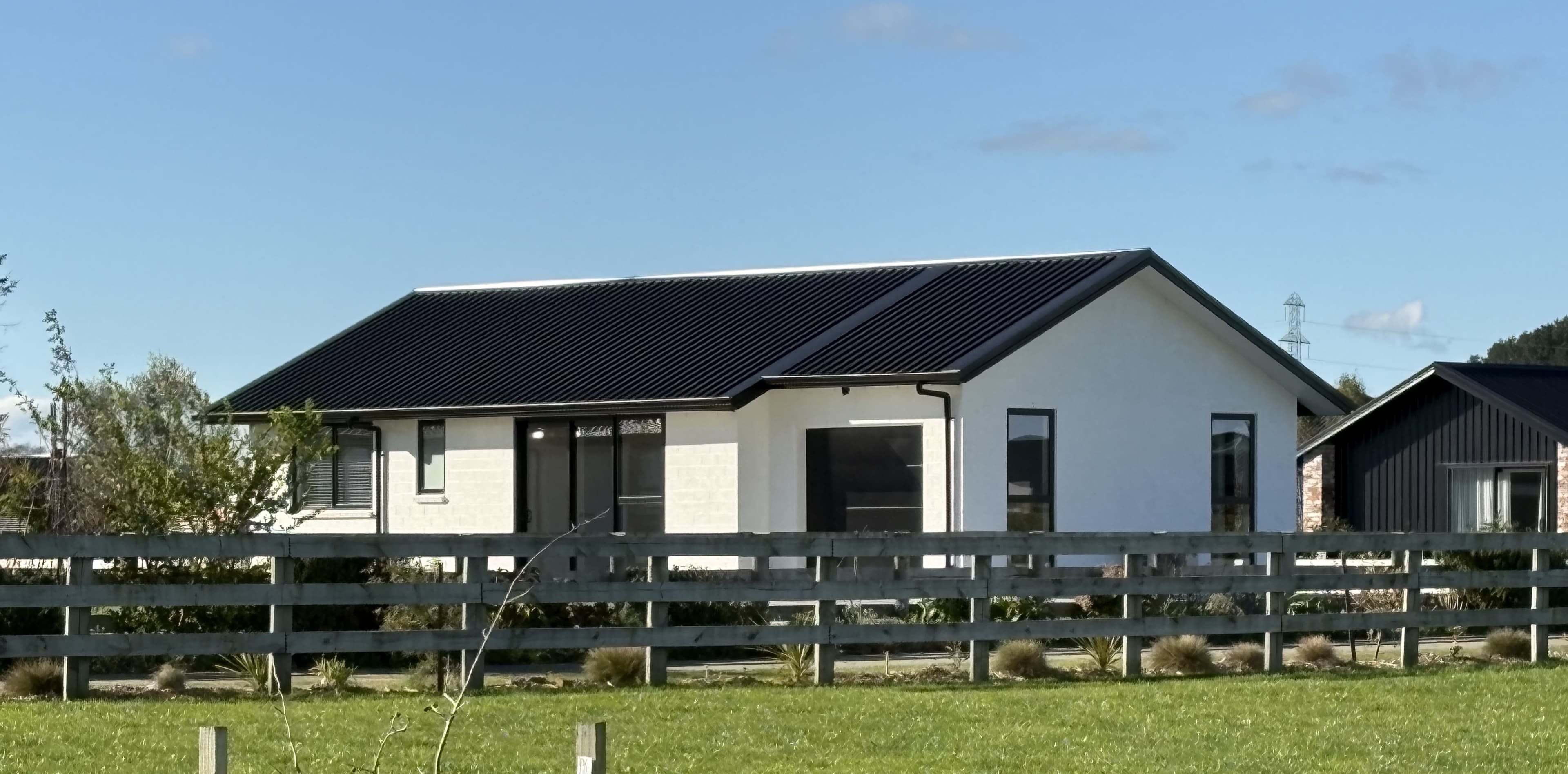 White gable-roof NZ-made transportable home on a Pirongia lifestyle section